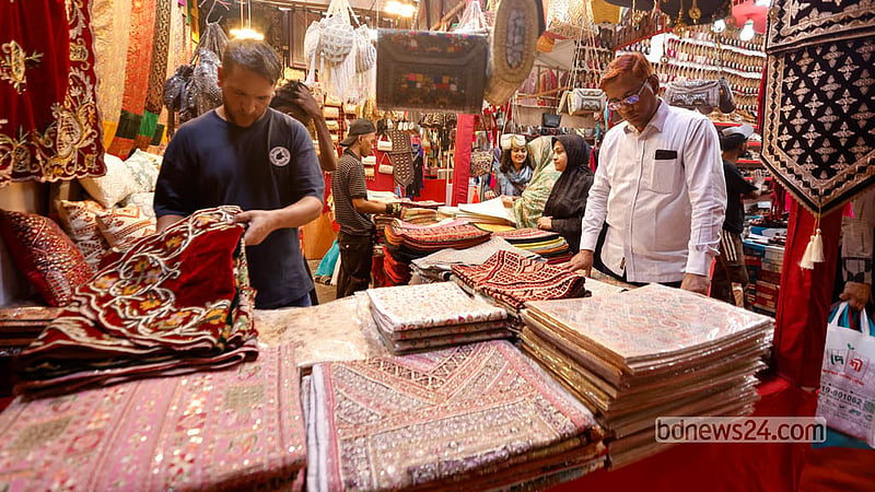 Shoppers check out velvet and fabric products featuring traditional craftsmanship at the fair in Dhaka’s Agargaon. Photo: Shamsul Haque Ripon