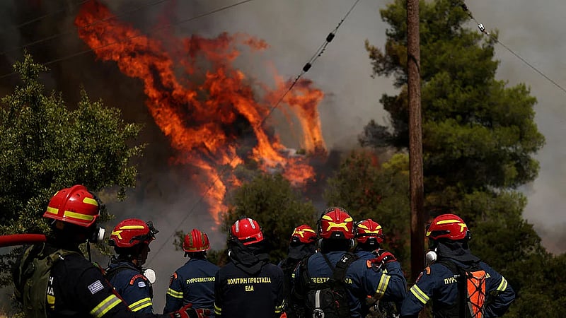Two die as firefighting helicopters collide in Greece, French blaze changes course