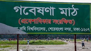 Children playing around in field with 'restricted access'