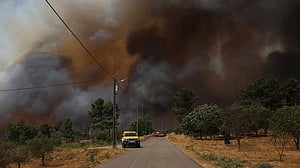 Firefighter injured in Portugal blaze as crew flees wall of fire