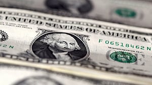 Dollar slides as Fed dents hawks, markets eye two more rate cuts