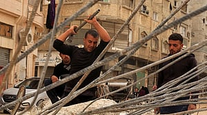 Desperate Gazans pull iron bars from rubble to construct tents and scratch out a living