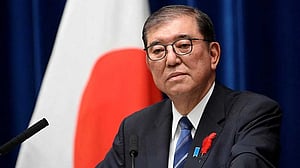 Japan PM vows to stay on after bruising election defeat