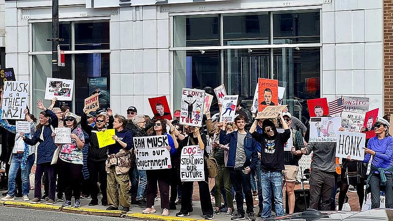 Anti-Musk protesters gather outside Tesla dealership in Washington
