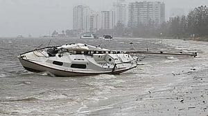 Thousands of Australians without power as ex-tropical cyclone lashes Queensland