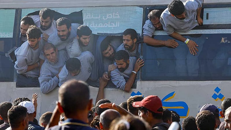 Palestinians cheer as freed prisoners begin to arrive home under ceasefire deal