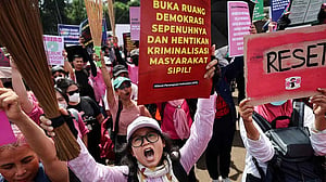 With brooms in hand as symbol for change, Indonesian women join Jakarta protests