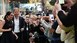 Prince Harry and Meghan arrive in Australia to a muted welcome