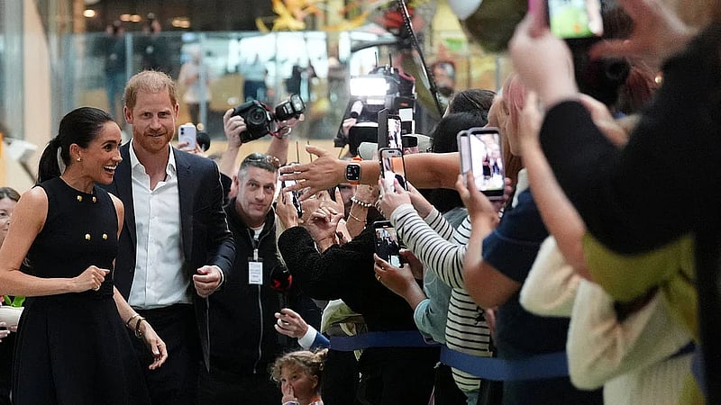 Prince Harry and Meghan arrive in Australia to a muted welcome
