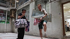 Back home, Hong Kong fire victim gathers memories from the ashes