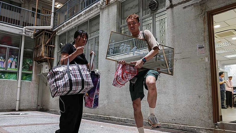 Back home, Hong Kong fire victim gathers memories from the ashes