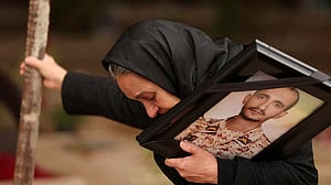 Iranian families weep as war dead are buried in Tehran cemetery