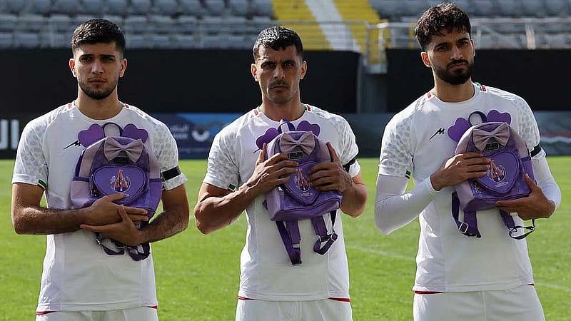 Iranian players hold schoolbags in protest over slain girls