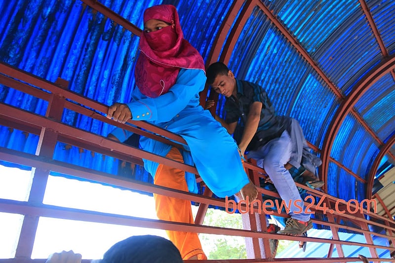 Desperate Eid-ul- Azha holiday makers mount the rooftop of a train to reach their destination at Airport Railway Station in Dhaka on Thursday.