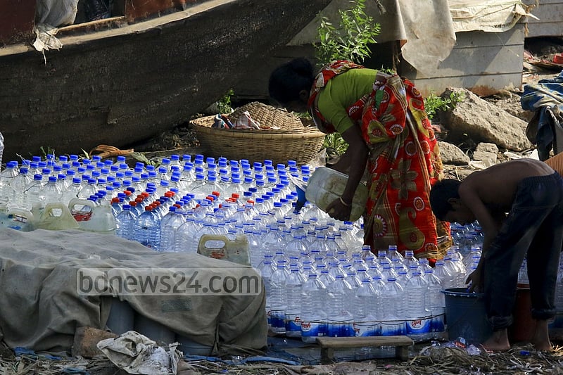Used water bottles are filled with drinking water in a filthy environment on the banks of Buriganga at Dhaka's Sadarghat to be sold to launch passengers. One bottle of such water is sold for Tk 5 to 10.