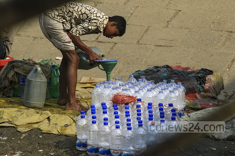 Used water bottles are filled with drinking water in a filthy environment on the banks of Buriganga at Dhaka's Sadarghat to be sold to launch passengers. One bottle of such water is sold for Tk 5 to 10.