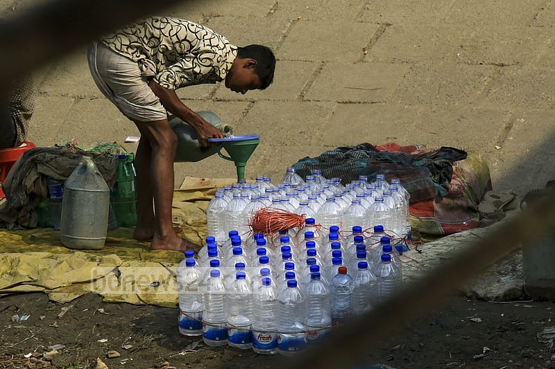 Used water bottles are filled with drinking water in a filthy environment on the banks of Buriganga at Dhaka's Sadarghat to be sold to launch passengers. One bottle of such water is sold for Tk 5 to 10.