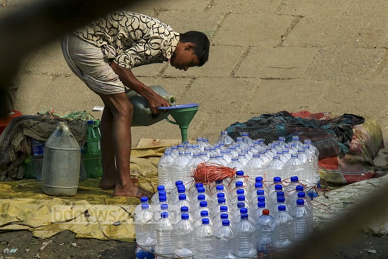 Used water bottles are filled with drinking water in a filthy environment on the banks of Buriganga at Dhaka's Sadarghat to be sold to launch passengers. One bottle of such water is sold for Tk 5 to 10.