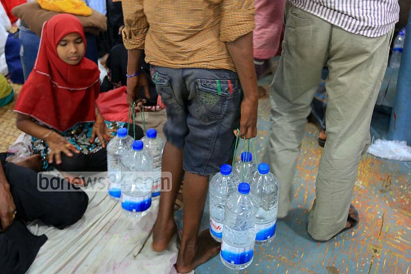 A vendor looks for customer to sell unhygienic bottled water at Dhaka's Sadarghat area.