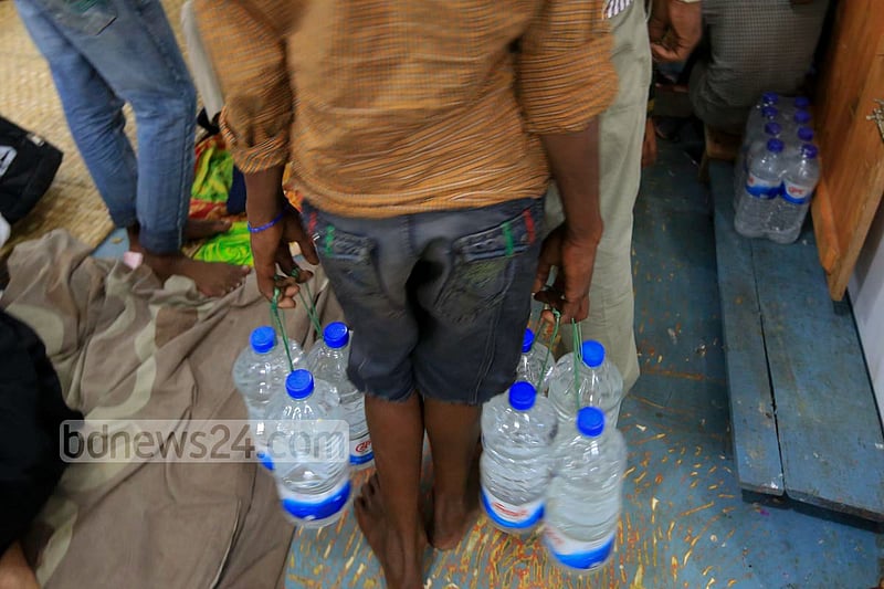 A vendor looks for customer to sell unhygienic bottled water at Dhaka's Sadarghat area.