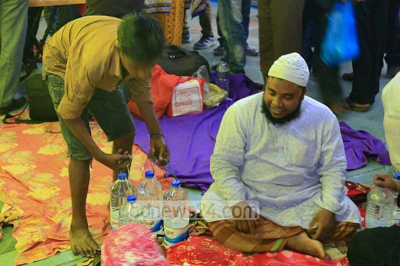 A vendor sells bottles of refilled unhygienic water to launch passengers at Dhaka's Sadarghat.