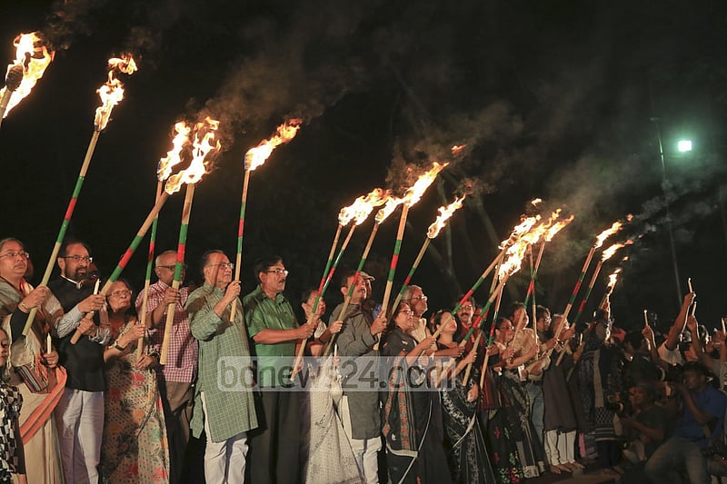 Ekattorer Ghatak-Dalal Nirmul Committee lights torches at Central Shaheed Minar in Dhaka on Wednesday night, demanding the observance of March 25 as `International Genocide Day'.