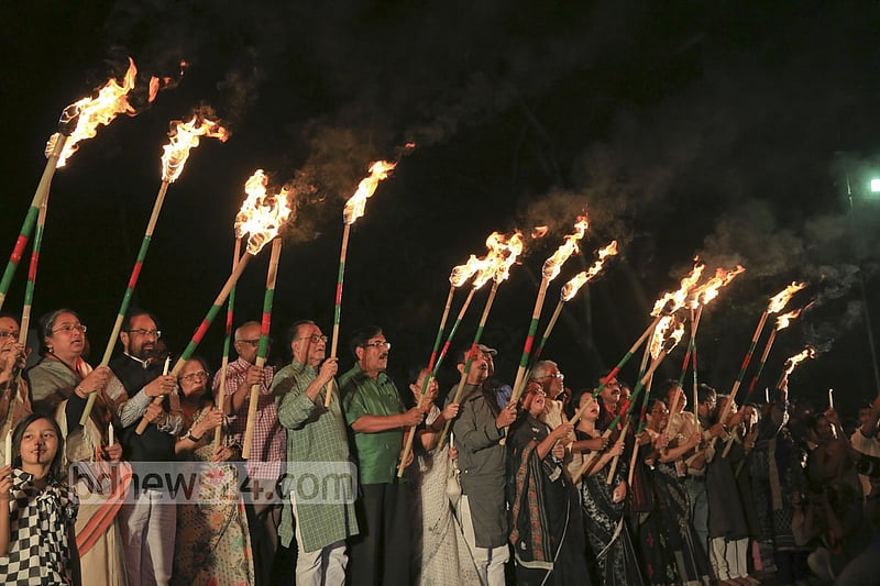 Ekattorer Ghatak-Dalal Nirmul Committee lights torches at Central Shaheed Minar in Dhaka on Wednesday night, demanding the observance of March 25 as `International Genocide Day'.