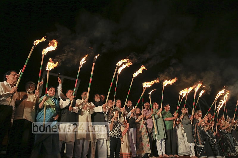 Ekattorer Ghatak-Dalal Nirmul Committee lights torches at Central Shaheed Minar in Dhaka on Wednesday night, demanding the observance of March 25 as `International Genocide Day'.