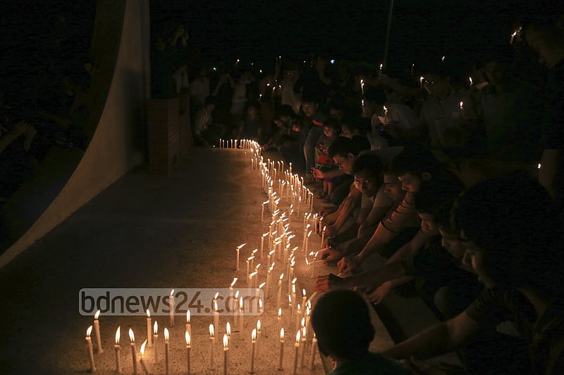 People light candles at the ‘Shaheed Bedi’ in memory of those killed by Pakistani army on the night of March 25, 1971, at Jagannath Hall on Tuesday.