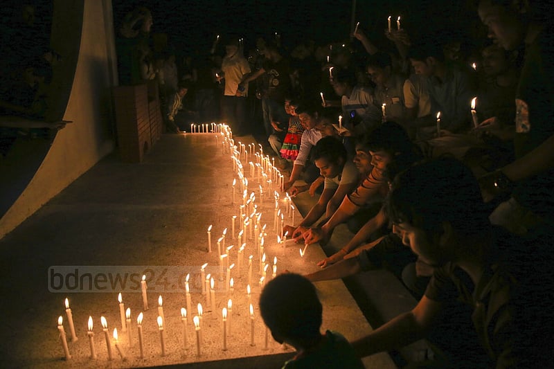 People light candles at the ‘Shaheed Bedi’ in memory of those killed by Pakistani army on the night of March 25, 1971, at Jagannath Hall on Tuesday.
