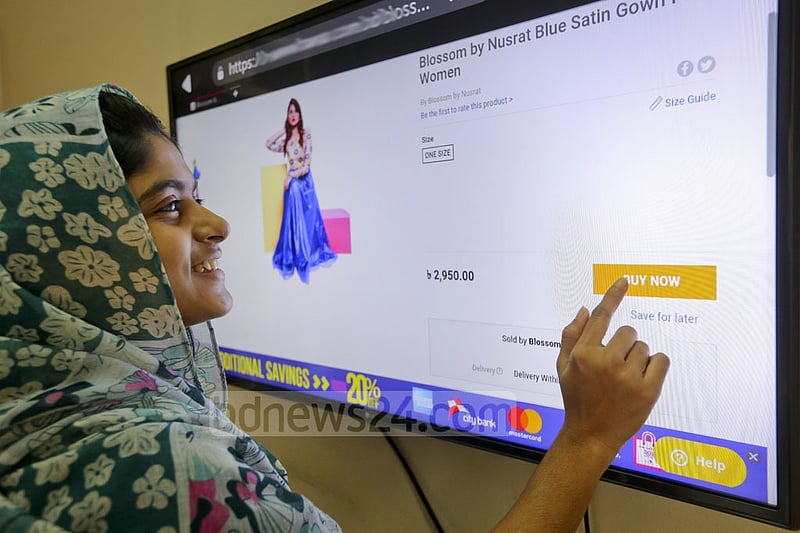 A woman gleefully gets done with her Eid shopping in the comfort of her home. Photo: asaduzzaman pramanik