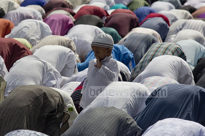 A young boy stands during Eid prayers at Dhaka’s National Eidgah grounds on Monday. Photo: mostafigur rahman