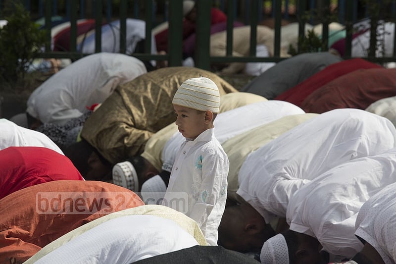 A young boy stands during Eid prayers at Dhaka’s National Eidgah grounds on Monday. Photo: mostafigur rahman