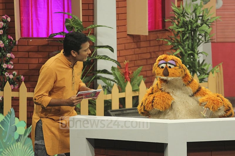 Puppetshow Sisimpur's character 'Halum' interacts with one of the hosts during the inauguration programme of a new project of the TV show. Photo: abdul mannan