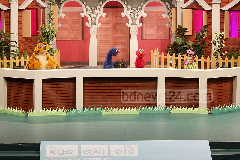 Puppetshow Sisimpur's 'Halum' and 'Tuktuki' with two other characters at the inauguration ceremony of a new project of the popular show on Wednesday. Photo: abdul mannan