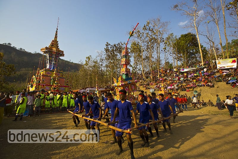 Young Marma men and women dance while carrying the tomb during the funeral. They believe the departed soul will reach the heaven in this way.