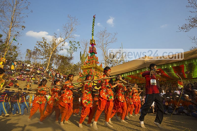Young Marma men and women dance while carrying the tomb during the funeral. They believe the departed soul will reach the heaven in this way.