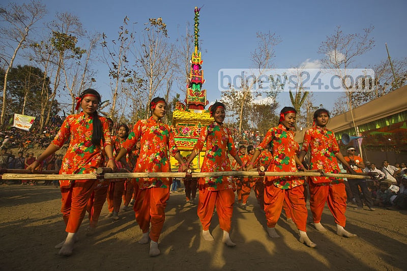 Young Marma men and women dance while carrying the tomb during the funeral. They believe the departed soul will reach the heaven in this way.