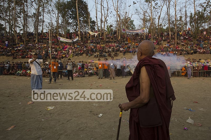 The tomb is lit with fireworks by a Buddhist monk.