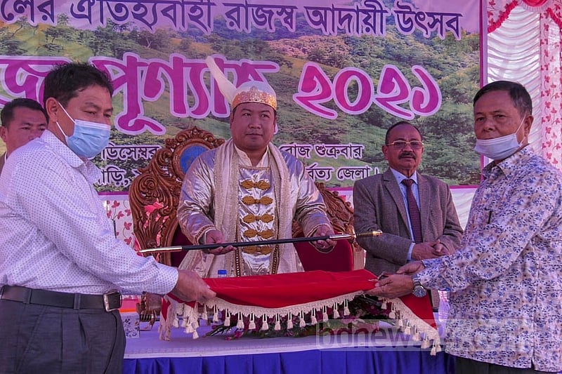 Mong Circle chief Raja Saching Prue Chowdhury is presented with a sword on the occasion of Rajpunyah, which is attended by guests in traditional attire on Friday, Dec 10, 2021. Photo: Samir Mallik