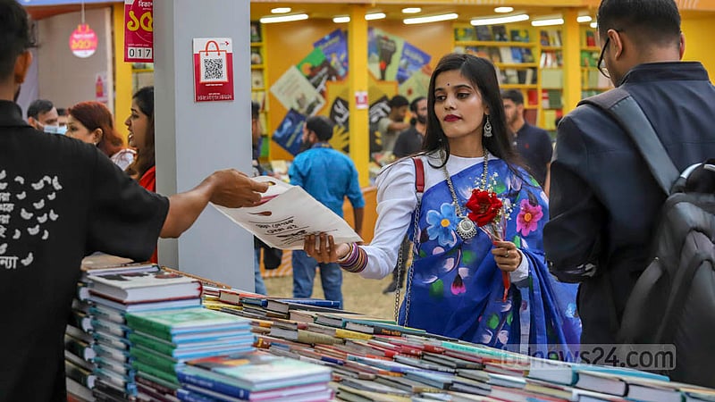 বৃহস্পতিবার অমর একুশে বইমেলার একটি স্টল থেকে বই কিনছেন একজন। ছবি: আসিফ মাহমুদ অভি