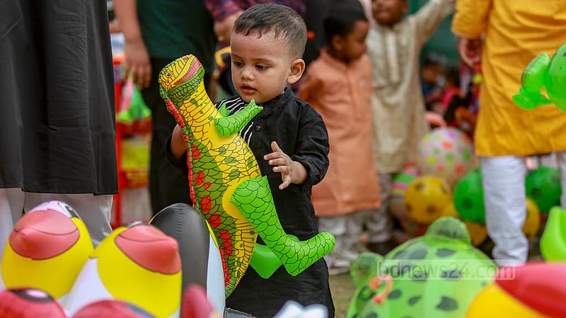 হাতিরঝিলে ঈদ আনন্দ উদযাপনে শনিবার এক শিশু ডাইনোসর নিয়ে খেলছে।&amp;nbsp;ছবি: তাওহীদুজ্জামান তপু