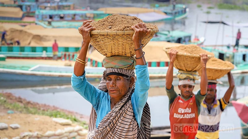 গাবতলী এলাকায় ট্রলার থেকে বালু খালাসের কাজ একসঙ্গে করছেন নারী-পুরুষরা। ছবি: আসিফ মাহমুদ অভি