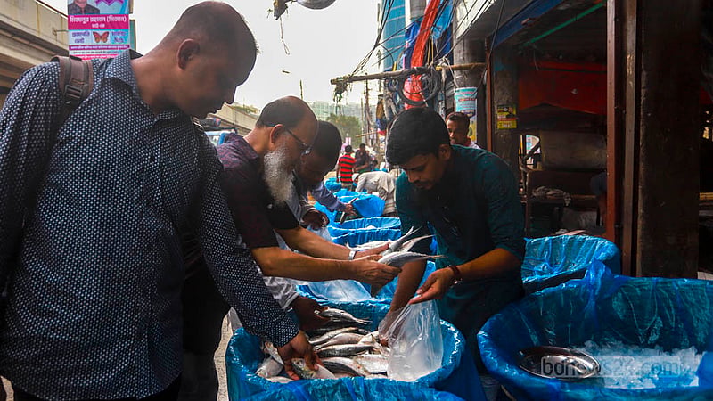 ঢাকার কারওয়ান বাজারের ফুটপাতে খুচরা ইলিশ কিনতে ক্রেতার ভিড়।&amp;nbsp;ছবি: তাওহীদুজ্জামান তপু