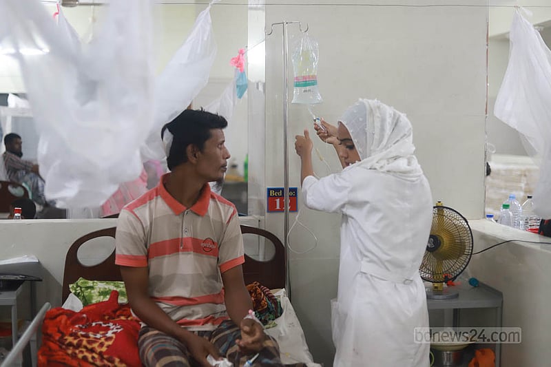 ঢাকার সোহরাওয়ার্দী মেডিকেল কলেজ হাসপাতালে ডেঙ্গু আক্রান্ত রোগীদের চিকিৎসা দিচ্ছেন এক সেবিকা।&amp;nbsp;ছবি: তাওহীদুজ্জামান তপু