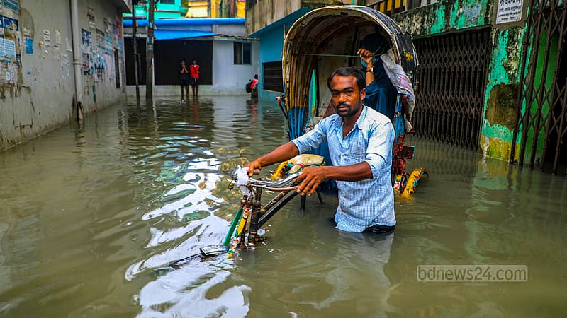 বৃষ্টি ও জোয়ারের পানির কারণে চট্টগ্রামের বহদ্দারহাট আরাকান সড়কে কোমর পানিতে যাত্রী নিয়ে চলতে বেগ পেতে হয় এ রিকশাচালককে।&amp;nbsp;ছবি: সুমন বাবু