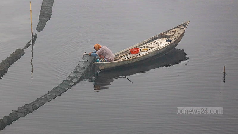 ধলেশ্বরী নদীর দূষিত কালো পানিতেই চায়না জাল দিয়ে মাছ ধরছেন এক জেলে।