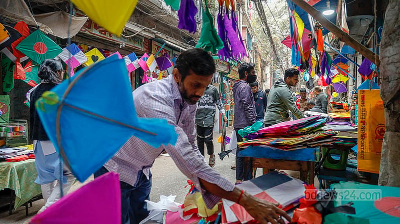 শাঁখারীবাজারে ঘুড়ি সাজিয়ে রাখছেন এক দোকানি। কাগজের যে ঘুড়ির দাম আগে ছিল ৫ টাকা তা এখন বেড়ে হয়েছে ১০ টাকা। নকশা করা ঘুড়ির দাম ১৫-২৫ টাকা আর বড় আকারেরগুলোর দাম শুরু ২৫ টাকা থেকে