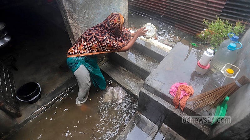 রাজধানীর নামা শ্যামপুর এলাকায় শুক্রবার ঘরবাড়িতে ঢুকে পড়া পানি সেচে বের করে দিচ্ছেন এক নারী। ঘরবাড়ি নিচুতে হওয়ায় অল্প বৃষ্টিতেই মেঝেতে পানি উঠে যায়