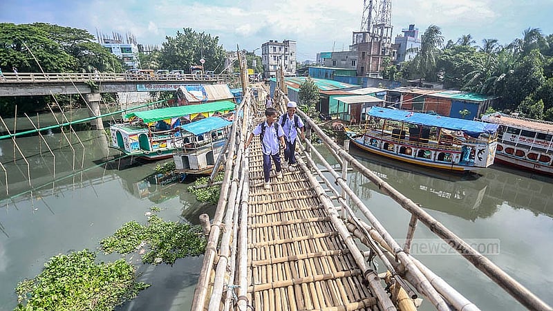 রাজধানীর খিলগাঁওয়ের ত্রিমোহনীতে নড়াই নদীর উপর বাঁশের সাঁকো দিয়ে আসা যাওয়া করছেন শিক্ষার্থীরা। সাবধান না থাকার কারণে মাঝে মধ্যেই ঘটছে দুর্ঘটনা
